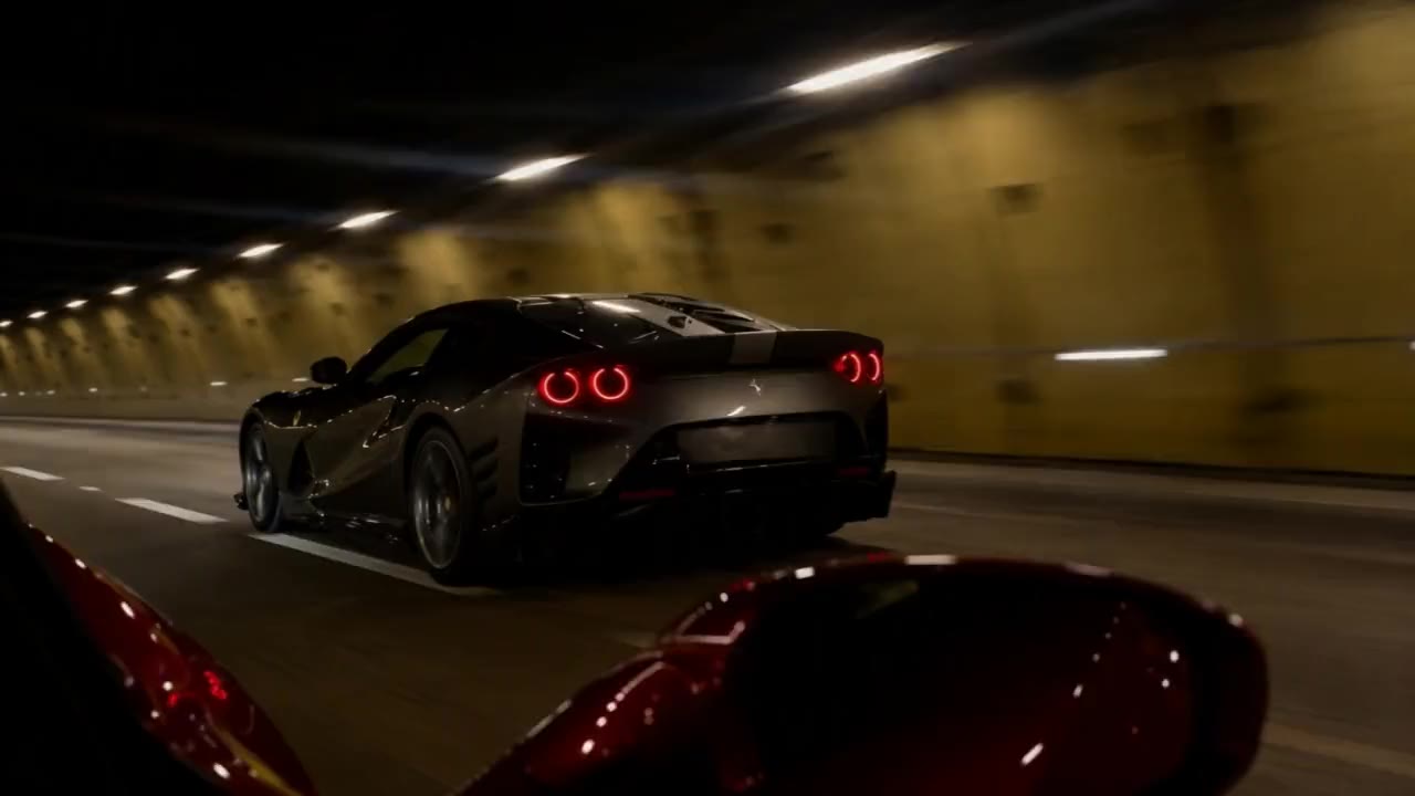 Tail lights streaking through a tunnel at night